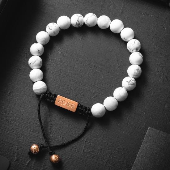 Howlite Bead Bracelet - Our Howlite Bead Bracelet Features Natural Stones, Waxed Cord and Brushed Rose Gold Steel Hardware. A Beautiful Addition to any Collection.
